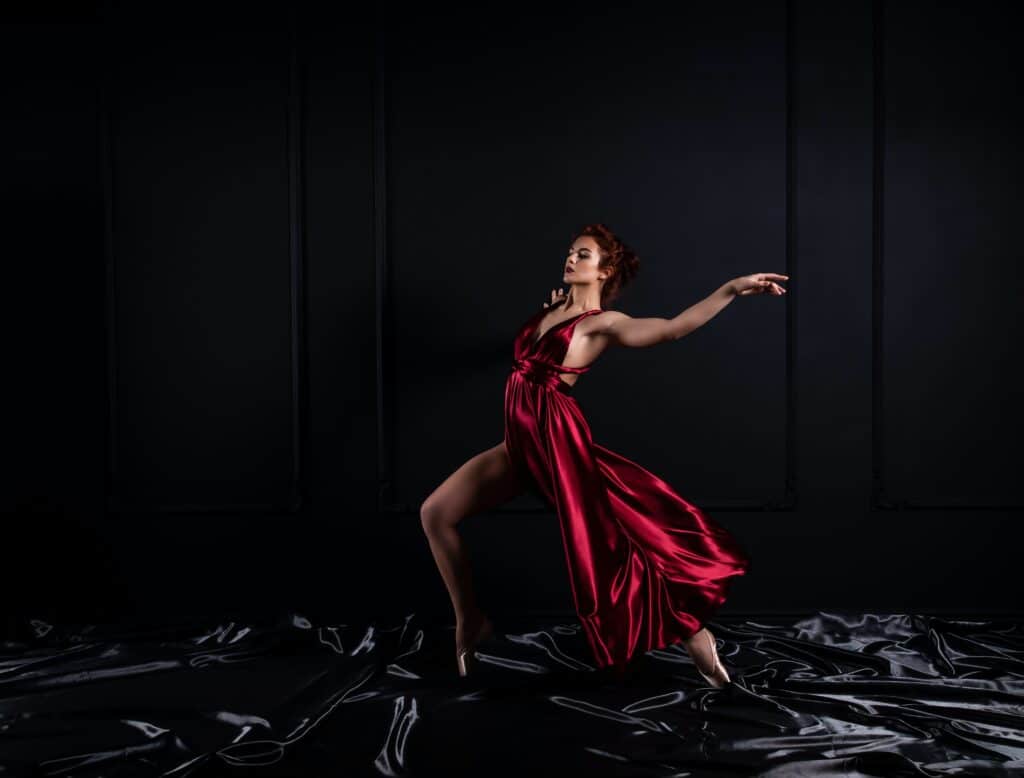 woman posing dynamically wearing red dress